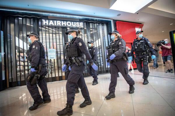 Members of the Victoria Police patrol through Chadstone Shopping Centre in Melbourne, Australia, on Sept. 20, 2020. (Darrian Traynor/Getty Images)