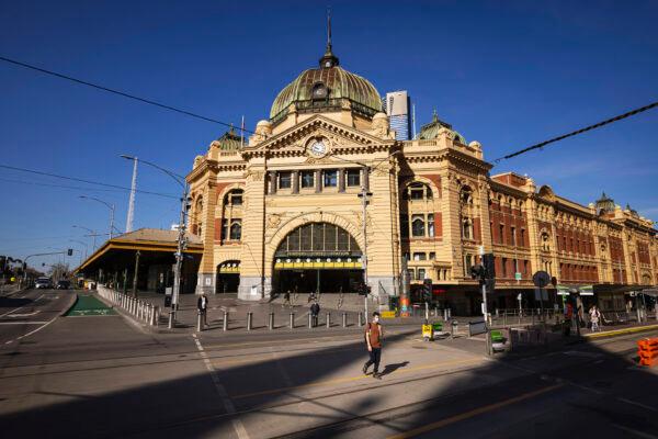 People cross a quiet Flinders Street in Melbourne on Sept. 1, 2021. (Daniel Pockett/Getty Images)