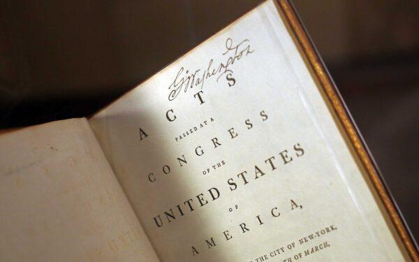George Washington’s personally annotated copy of the Acts of Congress is displayed on the 225th anniversary of the signing of the U.S. Constitution during an unveiling ceremony in Mount Vernon, Va., on Sept. 17, 2012. The rare volume includes Washington’s personal copy of the Constitution. (Win McNamee/Getty Images)