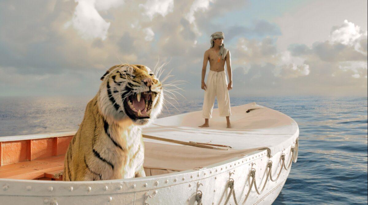 Pi Patel (Suraj Sharma) and a fierce Bengal tiger named Richard Parker rely on each other for survival during their epic journey in the comedy/drama "Life of Pi." (Rhythm & Hues/Twentieth Century Fox Film Corporation)