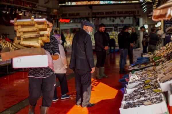 A man checks at prices at Karakoy fish market in Istanbul, Turkey, on Oct. 14, 2021. (Francisco Seco/AP Photo)