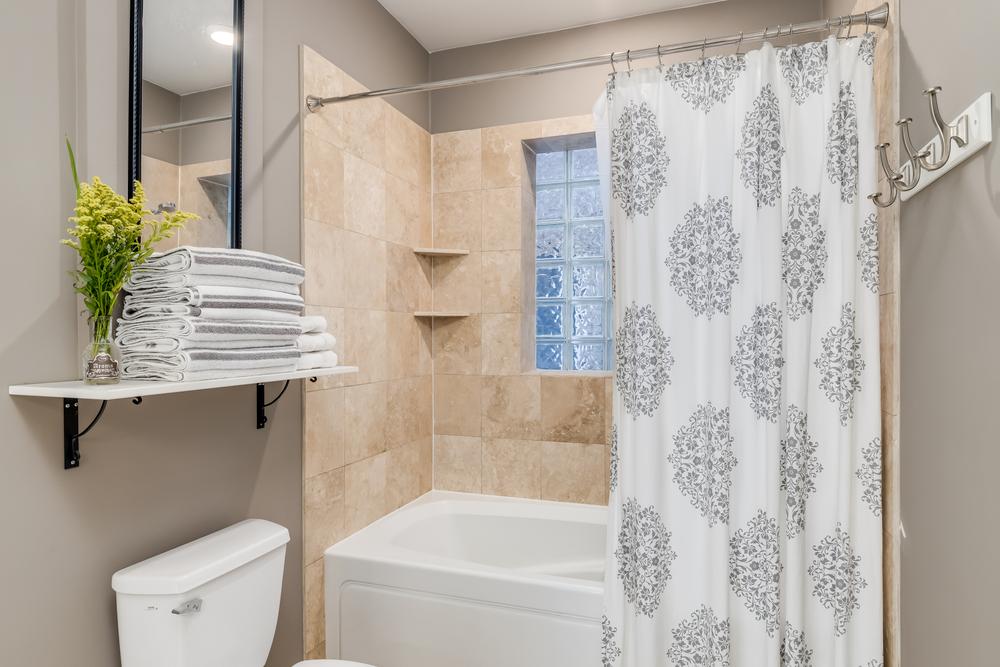 A new shower curtain will give your bathroom a refreshed look without the cost of a remodel. (Joe Hendrickson/Shutterstock)