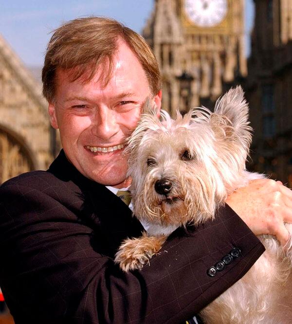 UK Conservative lawmaker David Amess outside the Houses of Parliament in Westminster, London, England, on Sept. 17, 2003. (John Stillwell/PA via AP)