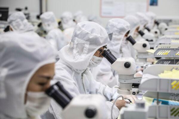 Workers produce LED chips at a factory in Huaian city in China's eastern Jiangsu Province on June 16, 2020. (STR/AFP)