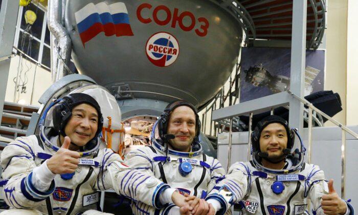 Roscosmos cosmonaut Alexander Misurkin, (C), and space flight participants Yusaku Maezawa, (L), and Yozo Hirano pose for a picture during a training session ahead of the expedition to the International Space Station at the Gagarin Cosmonauts Training Center in Star City outside Moscow, Russia, on Oct. 14, 2021. (Shamil Zhumatov/Pool Photo via AP)