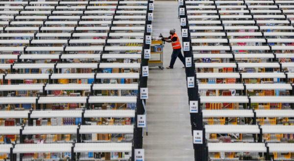 A worker collects orders at Amazon's fulfillment center in Rugeley, central England, on Dec. 11, 2012. (Phil Noble/Reuters)