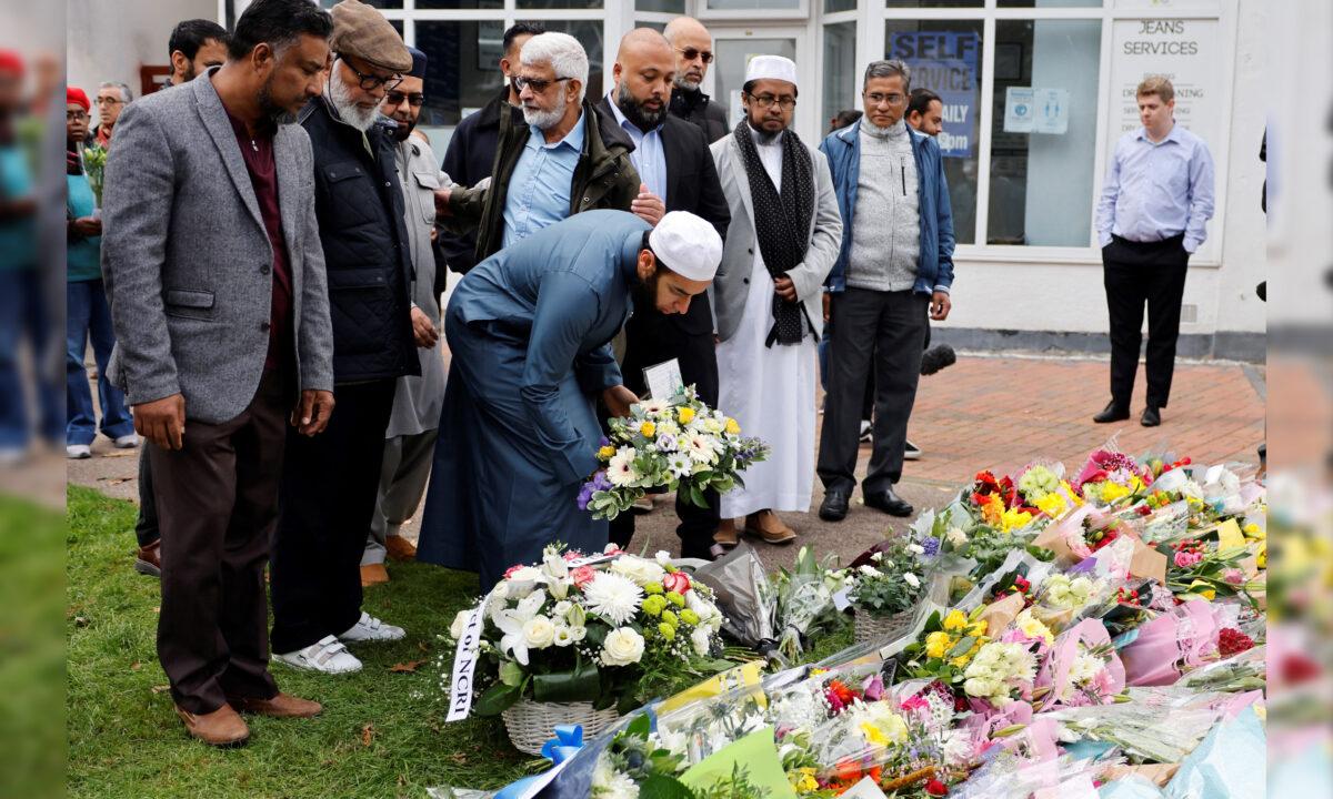 Members of the Muslim community lay floral tributes at the scene of the fatal stabbing of Conservative British lawmaker David Amess, at Belfairs Methodist Church in Leigh-on-Sea, a district of Southend-on-Sea, in southeast England on Oct. 16, 2021. (Tolga Akmen/AFP via Getty Images)