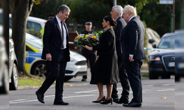 Britain's Prime Minister Boris Johnson (R), Britain's main opposition Labour Party leader Keir Starmer (L), Speaker of the House Lindsay Hoyle (2R), and Britain's Home Secretary Priti Patel (2L) lay floral tributes as at the scene of the fatal stabbing of Conservative British lawmaker David Amess at Belfairs Methodist Church in Leigh-on-Sea, England, on Oct. 16, 2021. (Tolga Akmen/AFP via Getty Images)
