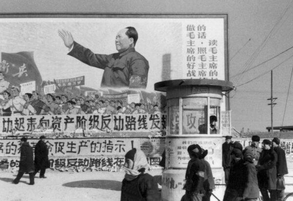 Residents walk around downtown Beijing near a poster showing Mao Zedong, in February 1967. (Jean Vincent/AFP via Getty Images)
