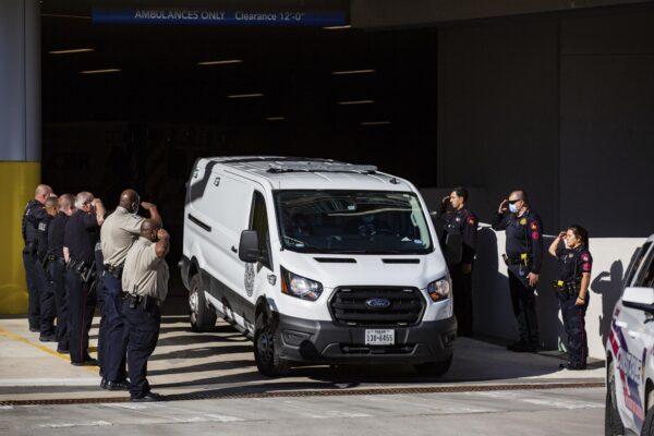 Harris County Medical Examiner van exits the Memorial Hermann Hospital transporting a Harris County Pct. 4 deputy who was shot and killed to the Harris County Institute of Forensic Sciences in Houston, Texas, on Oct. 16, 2021. (Marie D. De Jesús/Houston Chronicle via AP)