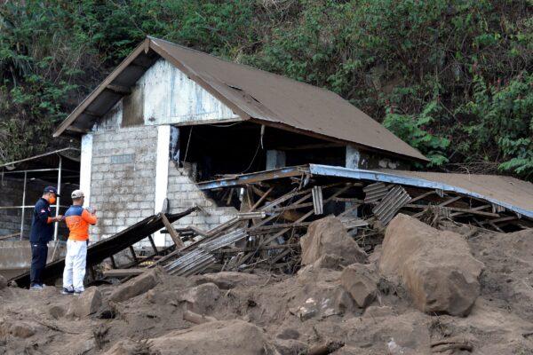 Rescuers inspect a house damaged by an earthquake-triggered landslide in Bangli, on the island of Bali, Indonesia on Oct. 16, 2021. (Dewa Raka/AP Photo)