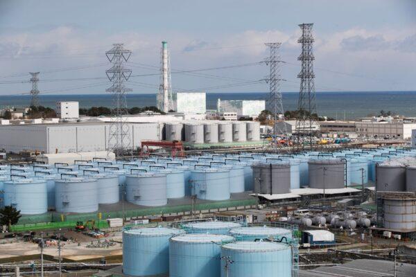 Nuclear reactors of No. 5 (center L) and 6 look over tanks storing water that was treated but still radioactive, at the Fukushima Daiichi nuclear power plant in Okuma town, Fukushima prefecture, northeastern Japan, on Feb. 27, 2021. (Hiro Komae/AP Photo)