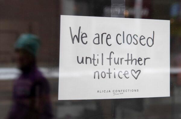 A sign on a shop window indicates the store is closed in Ottawa, on March 23, 2020. (Adrian Wyld/The Canadian Press)