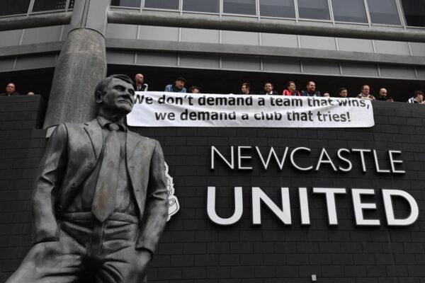 Newcastle United fans hang a banner outside the stadium at St. James’ Park in Newcastle-upon-Tyne, for the English Premier League football match between Newcastle United and Tottenham Hotspur, in England, on Oct. 17, 2021. (Paul Ellis/AFP via Getty Images)