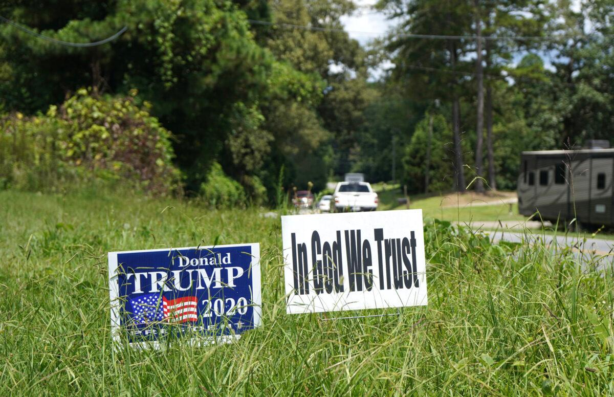 A Trump sign and an "In God We Trust" sign in Ellijay, Ga., on Aug. 18, 2021. (Jackson Elliott/The Epoch Times)