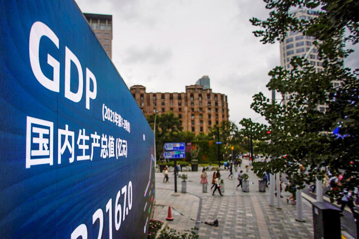 An electronic display showing the China GDP indexes is seen on a street in Shanghai, China, on Oct. 16, 2021. (Aly Song/Reuters)