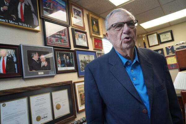 "America's Toughest Sheriff" Joe Arpaio considers former President Donald Trump his "hero." Here, Arpaio stands in front of the many pictures he's had taken with former U.S. presidents over the years in his office in Fountain Hills, Ariz., on Oct. 18, 2021. (Allan Stein/Epoch Times)