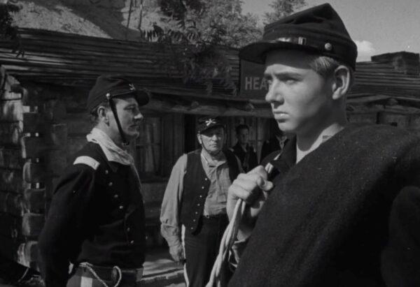 Lt. Col. Kirby Yorke (John Wayne, L) and his son, enlisted recruit Jefferson (Claude Jarman Jr., far right), in “Rio Grande.” (Republic Pictures)