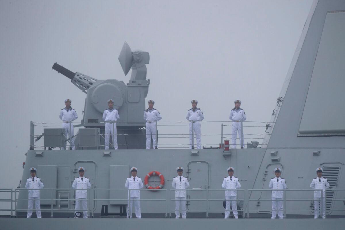 Sailors stand on the deck of the new type 055 guided missile destroyer Nanchang of the Chinese People's Liberation Army (PLA) Navy as it participates in a naval parade to commemorate the 70th anniversary of the founding of China's PLA Navy in the sea near Qingdao, in eastern China's Shandong Province on April 23, 2019. (Mark Schiefelbein/AFP via Getty Images)