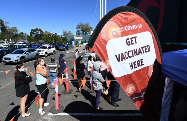 People queue to receive a Covid-19 vaccine at a Bunnings hardware store in Brisbane, Australia, on Oct. 16, 2021. (Dan Peled/Getty Images)