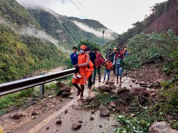 NDRF personnel rescue civilians stranded following heavy rains at Chhara village near Nainital, Uttarakhand, India, on Oct. 20, 2021. (National Disaster Response Force via AP)