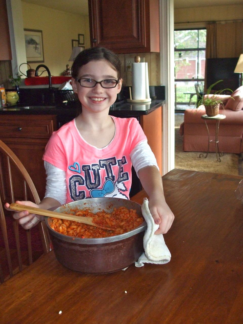 One of the author's grandchildren making her mother's macaroni. (Courtesy of Patricia McAdams)