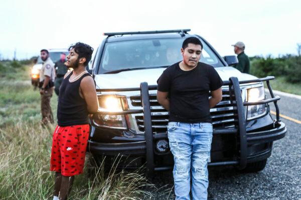 Texas State Troopers arrest two U.S. citizens who were transporting three illegal aliens to San Antonio, in Kinney County, Texas, on Oct. 20, 2021. (Charlotte Cuthbertson/The Epoch Times)