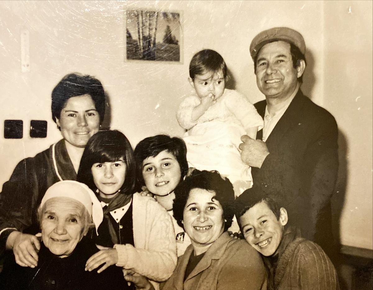 (Back, L-R) Elida Dakoli's mother, Lili Dakoli, and uncle, Meti Dakoli (who's holding Elida as a baby); (Front, L-R) Grandmother Jaja Dakoli, Elida's cousins and aunty, and Elida's brother; all sharing a two-bedroom apartment during Albania's communist era. (Courtesy of <a href="http://www.elidadakoli.com/">Elida Dakoli</a>)