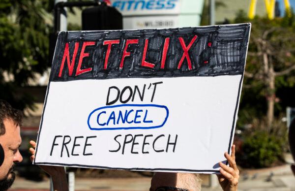 A counter-protestor holds a sign voicing support for a Dave Chapell comedy special airing on Netflix gather in front of Netflix's Vine Street offices in Los Angeles, Calif., on Oct. 20, 2021. (John Fredricks/The Epoch Times)