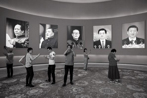 A group of people take pictures in front of portraits of (L-R) late Chinese chairman Mao Zedong and former Chinese leaders Deng Xiaoping, Jiang Zemin, Hu Jintao and current leader Xi Jinping at an exhibition marking the country's achievements over the past 70 years, ahead of the 70th anniversary of the founding of the People's Republic of China, in Beijing on Sept. 26, 2019. (Wang Zhao/AFP via Getty Images)