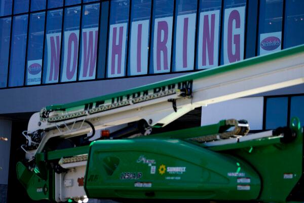 A hiring sign is displayed at a furniture store window in Downers Grove, Ill., on  Sept. 17, 2021. (Nam Y. Huh/AP Photo)