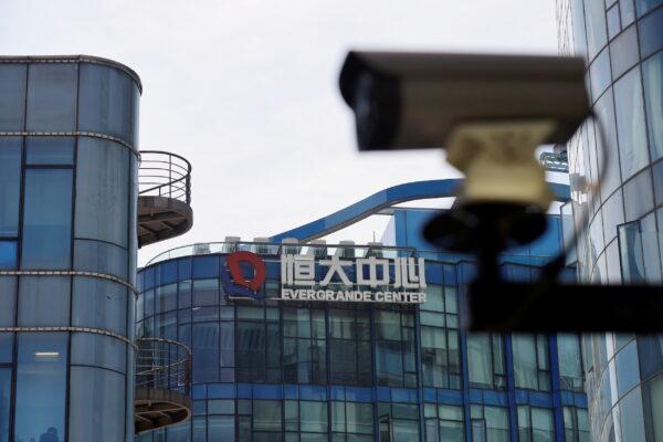 A surveillance camera is seen near the logo of the China Evergrande Group at the Evergrande Center in Shanghai on Sept. 24, 2021. (Reuters/Aly Song)