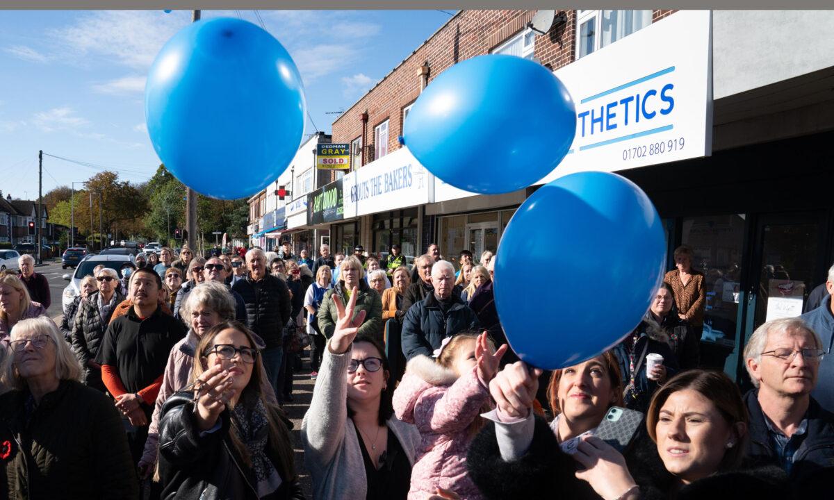 Shopkeepers and local residents release balloons after a two-minute silence in memory of MP Sir David Amess in Eastwood Road North, Leigh-on-Sea, Essex, England, on Oct. 22, 2021. (Stefan Rousseau/PA)