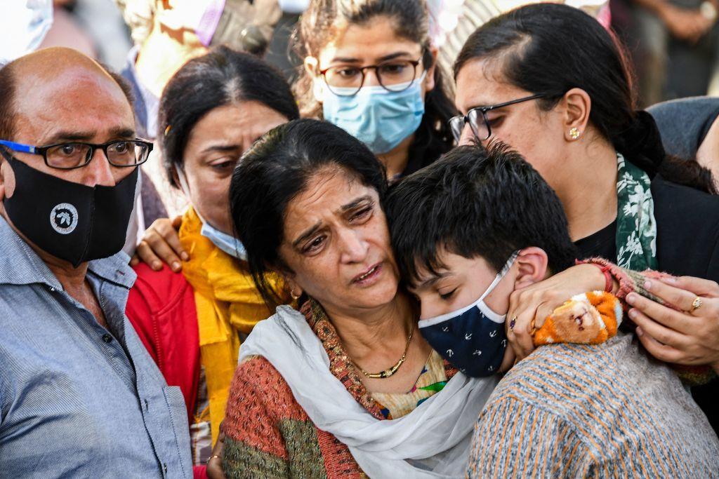 Wife (2R) of Makhan Lal Bindroo, a pandit businessman and owner of a pharmacy, mourns around his body after terrorists killed three civilians in separate street shootings a day before, at a cremation ground in Srinagar on Oct. 6, 2021. (Tauseef Mustafa/AFP via Getty Images)