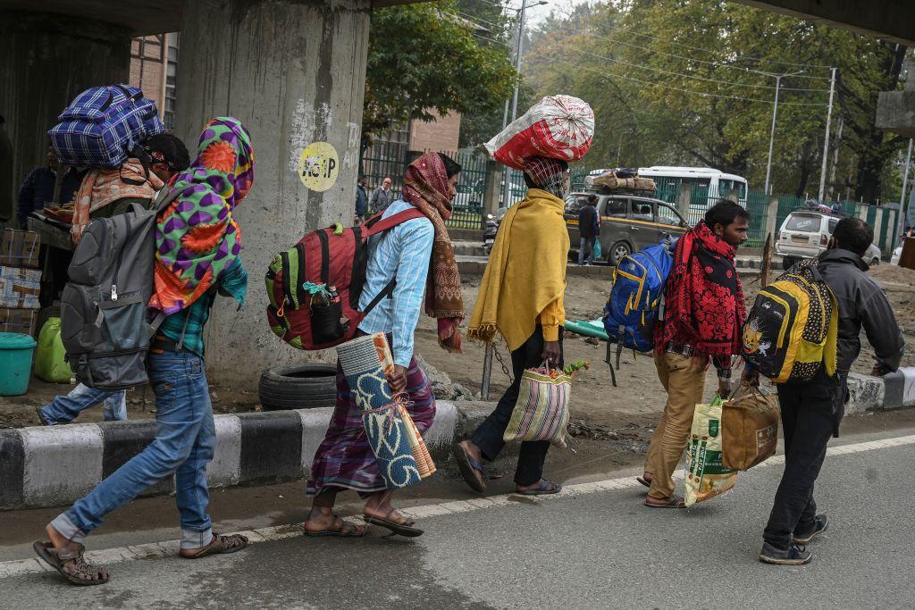 Workers carry their belongings as they return back to their native places at a bus terminal in Srinagar on Oct. 19, 2021 days after two laborers from India's Bihar state were reportedly killed by terrorists. (Tauseef Mustafa/AFP via Getty Images)