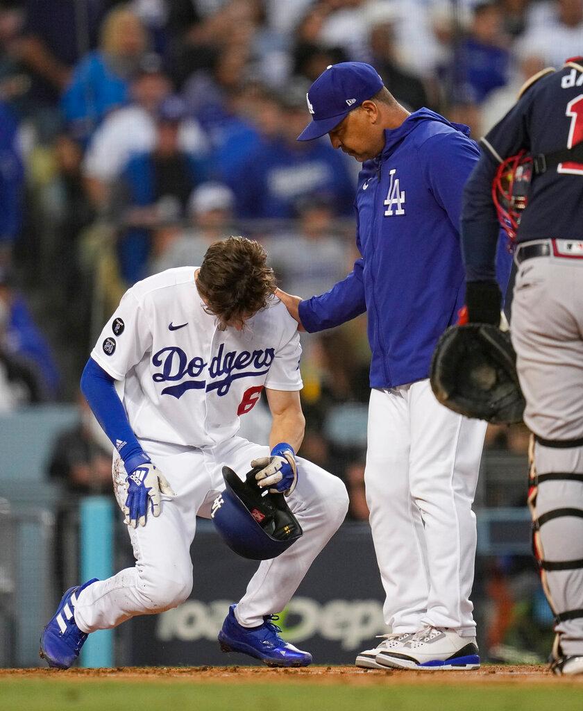 Manager Dave Roberts of the Los Angeles Dodgers checks on Trea Turner after he was hit with a pitch in the second inning in Game 5 of baseball's National League Championship Series in Los Angeles, Calif., on Thursday, Oct. 21, 2021. (Ashley Landis/AP Photo)