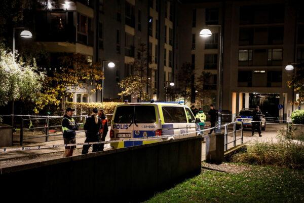 Ambulance and police stand at the scene where Swedish rapper Einar was shot to death, in Hammarby Sjostad district, in Stockholm, Sweden, early on Oct. 22, 2021. (Christine Olsson/TT News Agency via AP)