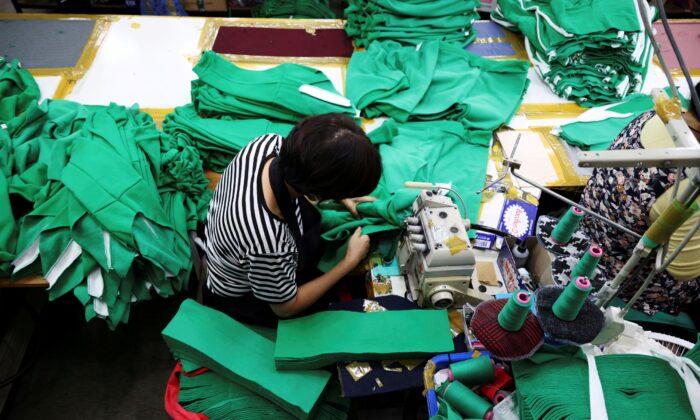 A woman works on tracksuits inspired by Netflix series "Squid Game" at a clothing factory in Seoul, South Korea, on Oct. 21, 2021. (Kim Hong-Ji/Reuters)