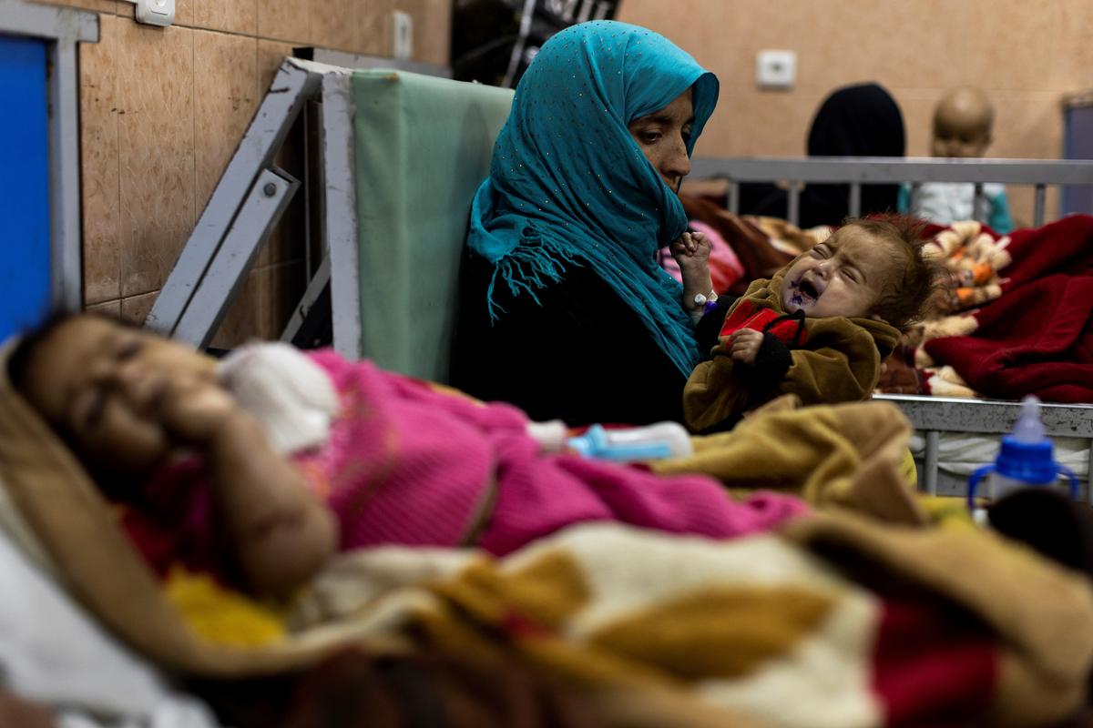 Farzana, 30, holds her 1-year-old baby, Omar, at the malnutrition ward for infants of Indira Gandhi Children's hospital in Kabul, Afghanistan, on Oct. 23, 2021. (Jorge Silva/Reuters)