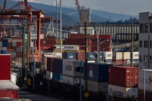 Cargo containers sit on idle train cars at the Port of Vancouver on Feb. 21, 2020. (The Canadian Press/Darryl Dyck)