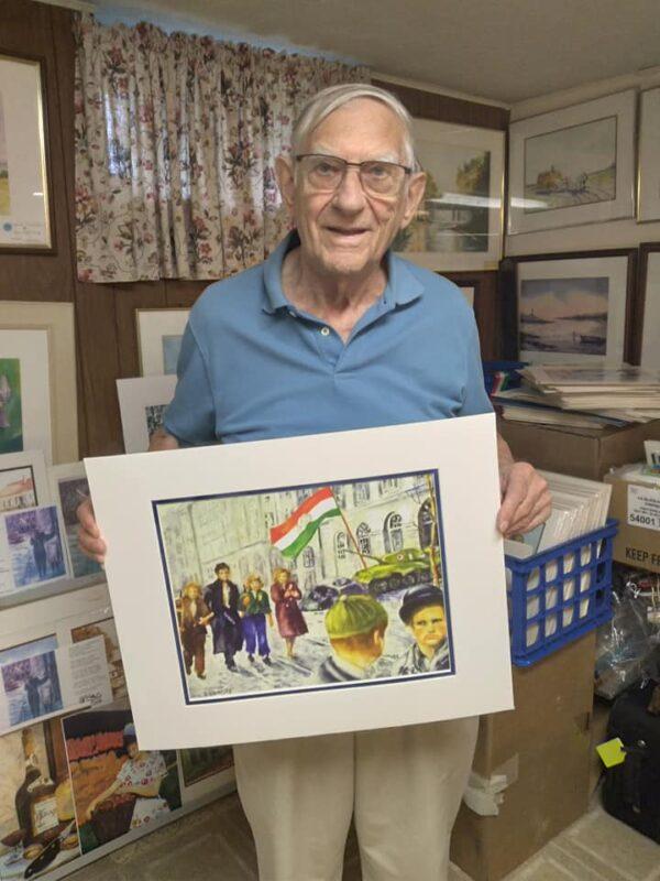 Emory Bogardy, a retired mechanical engineer and prolific watercolor artist of Cleveland, Ohio, left his home of Esztergom, Hungary in the wake of the 1956 Hungarian Revolution. Bogardy, 89, is pictured with one of his paintings depicting a famous scene from the '56 uprising. (Mike Sakal for The Epoch Times)