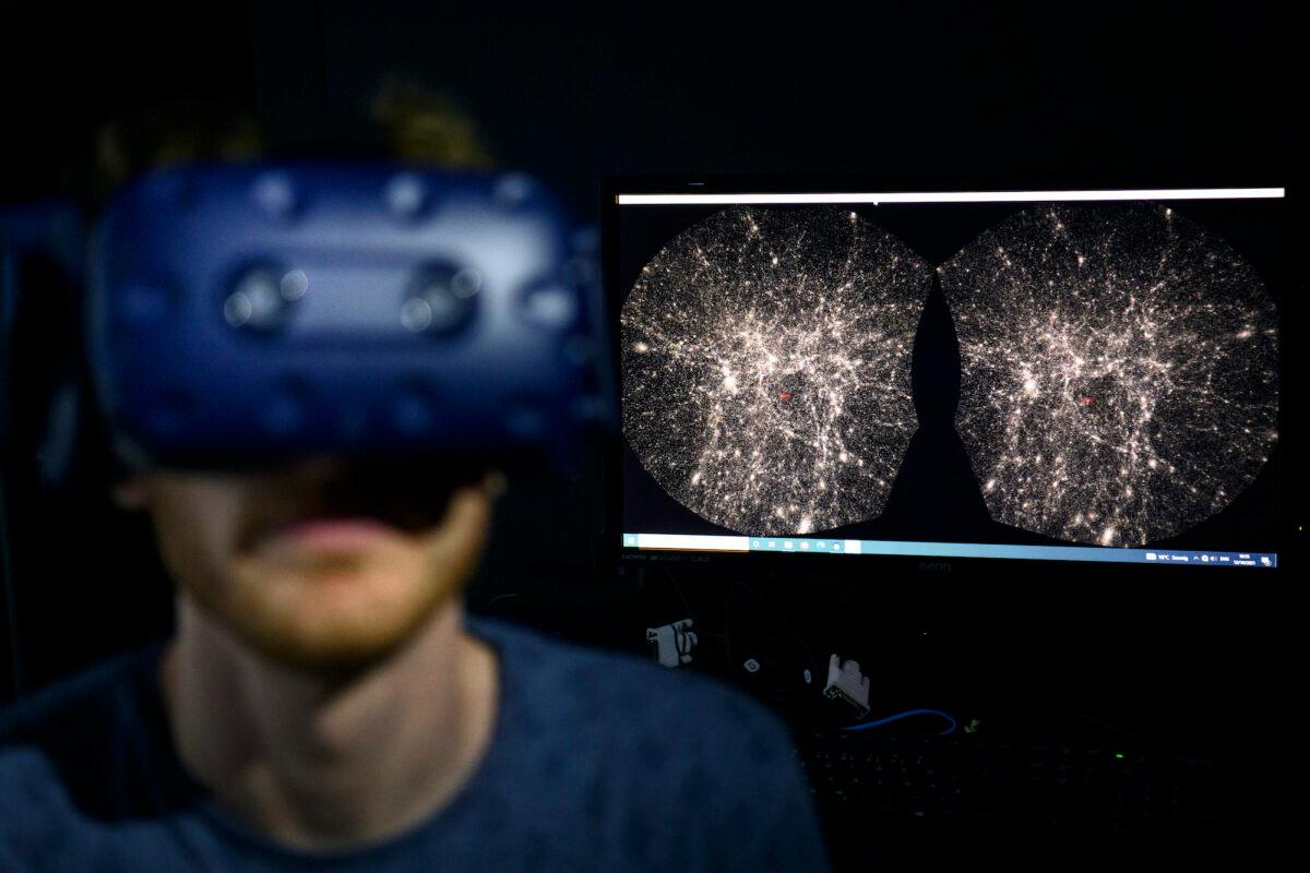 A software engineer explores with a virtual reality helmet the most detailed 3D map of the universe with virtual reality software developed by the Swiss Federal Institute of Technology, in St-Sulpice near Lausanne, Switzerland, on Oct. 12, 2021. (Laurent Gillieron/Keystone via AP)