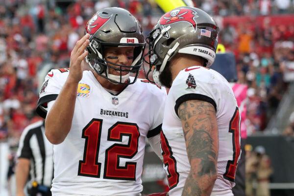 Tampa Bay Buccaneers quarterback Tom Brady (12) celebrates with wide receiver Mike Evans (13) after Evans caught a touchdown pass during the first half of an NFL football game against the Chicago Bears in Tampa, Fla., on Oct. 24, 2021. (Mark LoMoglio/AP Photo)