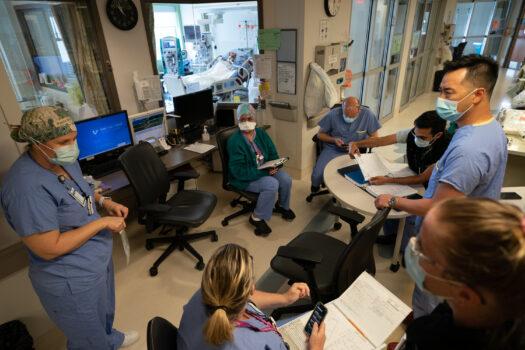 Nurses and doctors have their morning briefing about a COVID-19 patient at the COVID-19 Intensive Care Unit at a hospital in Surrey, B.C., on June 4, 2021. (The Canadian Press/Jonathan Hayward)