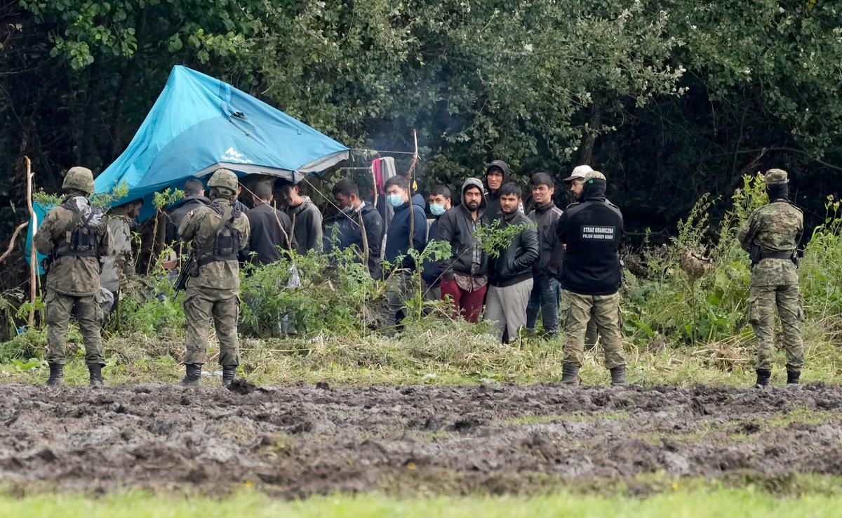 Polish security forces block illegal aliens stuck on the border with Belarus in Usnarz Gorny, Poland, on Sept. 1, 2021. (Czarek Sokolowski/Reuters)