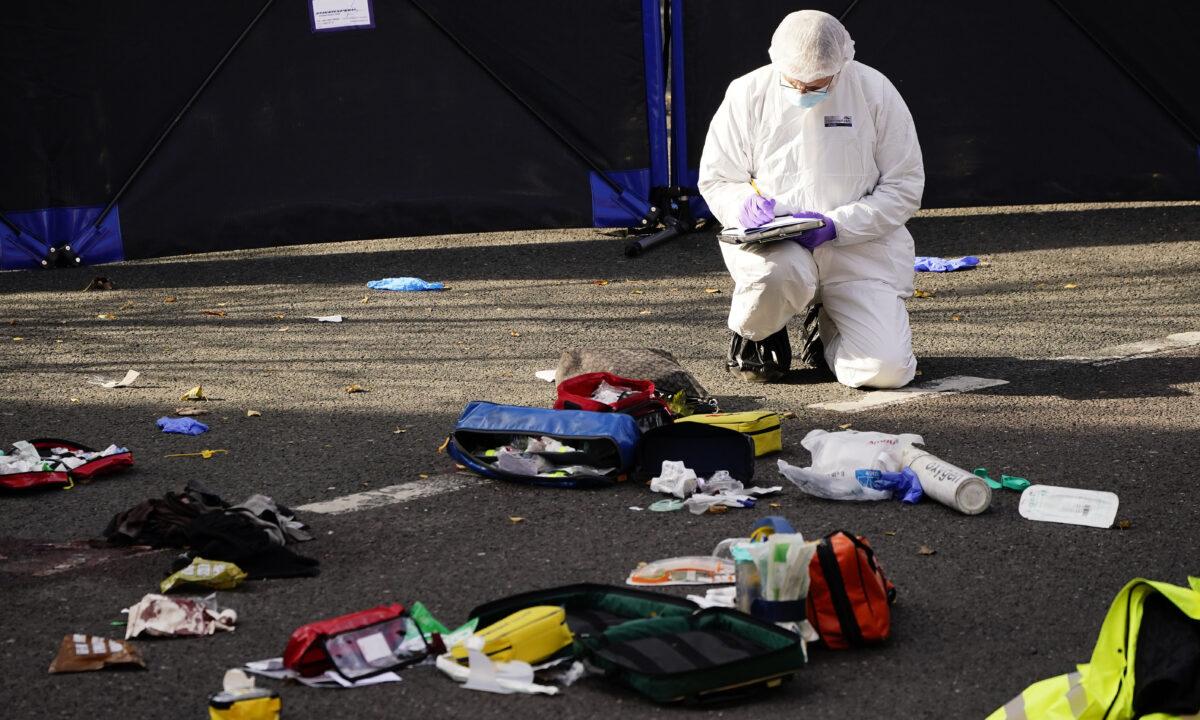 A forensic officer at the scene where two teenage boys died at Regency Court in Brentwood, Essex, England, on Oct. 24, 2021. (Aaron Chown/PA)