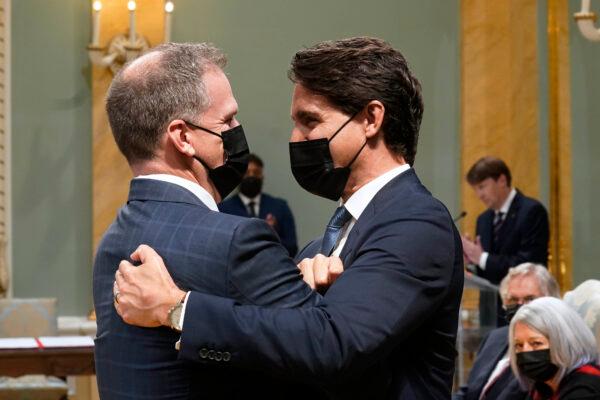 Prime Minister Justin Trudeau, right, congratulates Mark Holland, government House leader, at a cabinet swearing-in ceremony at Rideau Hall in Ottawa, Oct. 26, 2021. (The Canadian Press/Adrian Wyld)