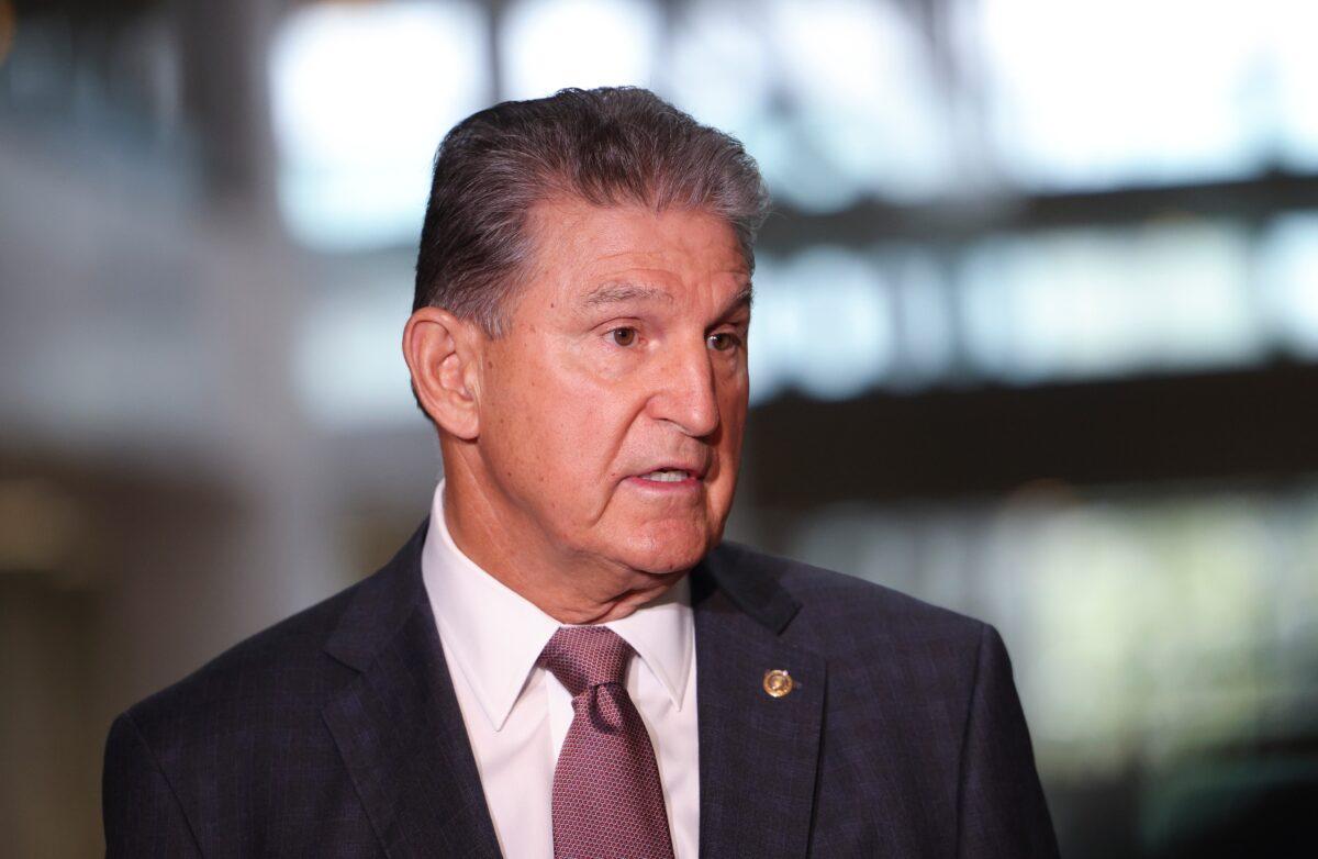 Sen. Joe Manchin (D-W.Va.) speaks to reporters outside of his office on Capitol Hill in Washington on Oct. 6, 2021. Manchin spoke on the debt limit and the infrastructure bill. (Kevin Dietsch/Getty Images)