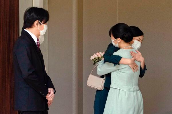 Japan's Princess Mako, right, hugs her sister Princess Kako, watched by her parents Crown Prince Akishino and Crown Princess Kiko, before leaving her home in Akasaka Estate in Tokyo, Japan, on Oct. 26, 2021. (Koki Sengoku/Kyodo News via AP)