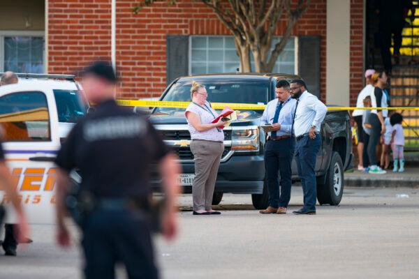 Law enforcement officials investigate a scene where, according to Harris County Sheriff Ed Gonzalez, three juveniles were found living alone along with the skeletal remains of another person, possibly a juvenile, in a third floor apartment at the CityParc II at West Oaks Apartments in west Houston, on Oct. 24, 2021. (Mark Mulligan/Houston Chronicle via AP)